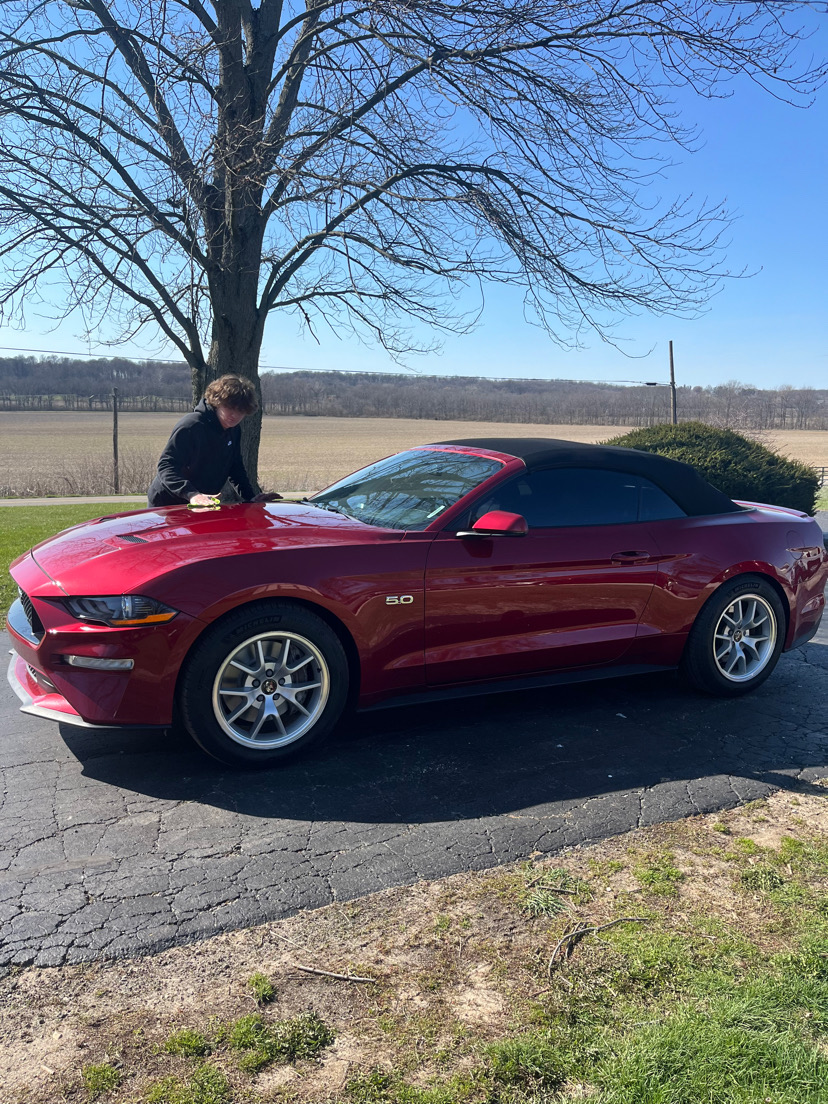 Aaron working on a red convertible